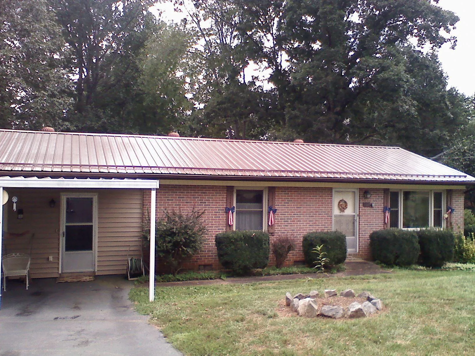Bronze metal roof and carport on a brick ranch home — Roof Repair work by our crew in Wayne